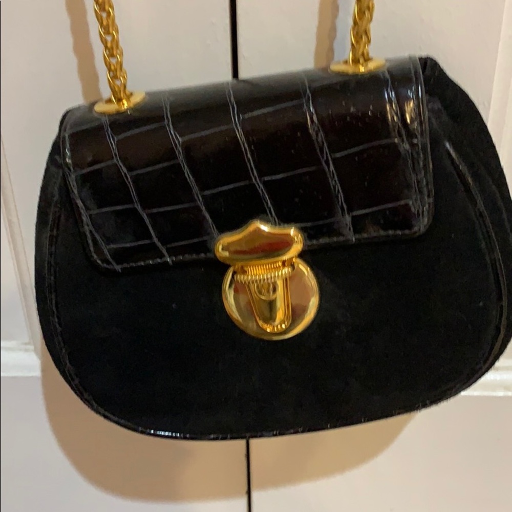 Black shoulder bag with gold chain strap